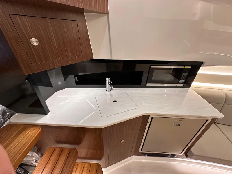 Slide: The Image of Modern kitchen area in 2023 Sea Ray Sundancer 370 OB yacht with sleek cabinetry. - 18