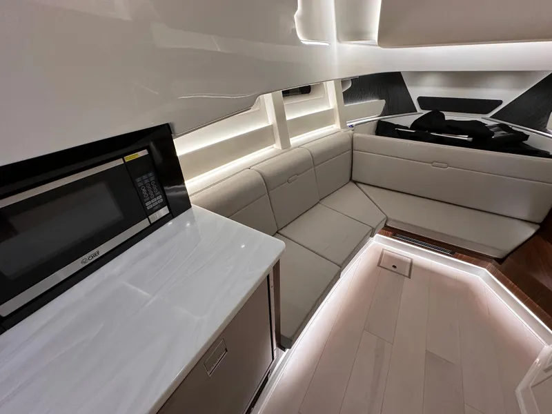 Slide: The Image of Luxurious interior of 2023 Sea Ray Sundancer 370 OB with modern seating and kitchenette. - 19