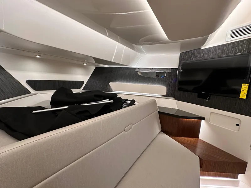 Slide: The Image of Luxurious interior of 2023 Sea Ray Sundancer 370 OB with modern seating and TV. - 21