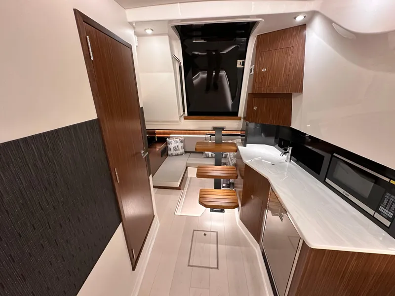 Slide: The Image of 2023 Sea Ray Sundancer 370 OB interior with modern kitchen and seating area. - 22