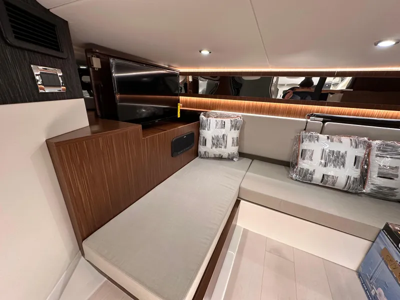 Slide: The Image of 2023 Sea Ray Sundancer 370 OB cabin interior with modern seating and TV. - 26