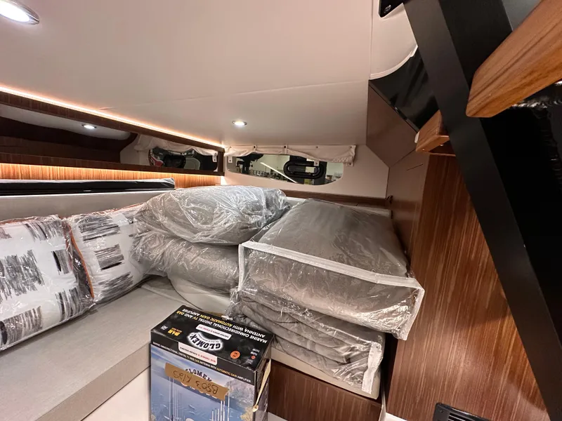 Slide: The Image of Interior cabin of 2023 Sea Ray Sundancer 370 OB with packaged cushions and a box. - 28