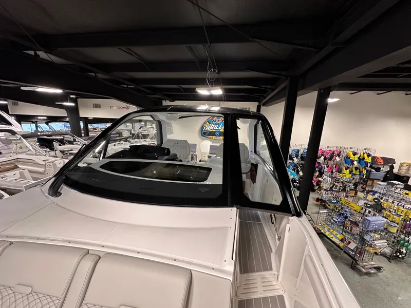 Slide: The Image of 2023 Sea Ray Sundancer 370 OB displayed in a showroom with boating accessories. - 29