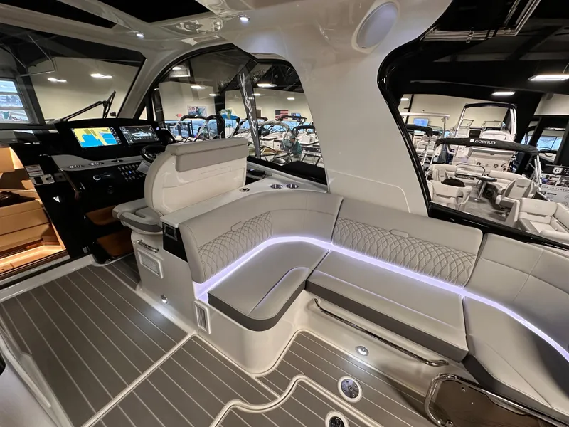 Slide: The Image of 2023 Sea Ray Sundancer 370 OB interior with modern seating and ambient lighting. - 42