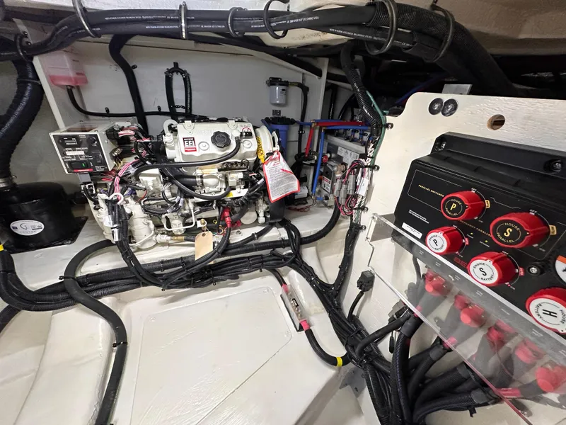 Slide: The Image of Engine room of 2023 Sea Ray Sundancer 370 OB with complex wiring and control panel. - 43