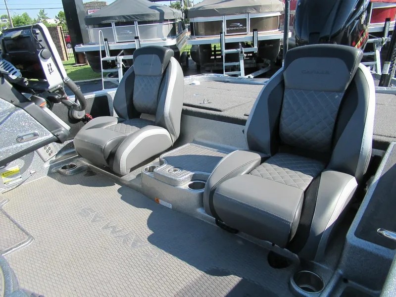 Slide: The Image of 2021 Caymas CX21 Pro boat interior with dual gray seats and center console. - 3