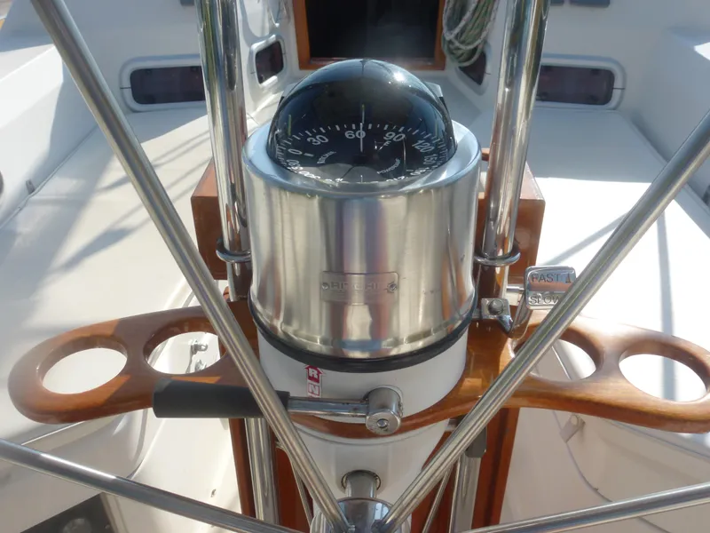 Slide: The Image of Compass and steering wheel of a 1990 Sabre 425 sailboat. - 23