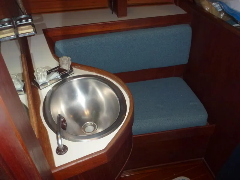 Slide: The Image of Compact sink and seating area in 1990 Sabre 425 sailboat with blue upholstery. - 29
