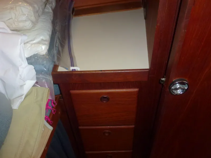 Slide: The Image of Wooden drawers and storage area inside a 1990 Sabre 425 sailboat. - 30