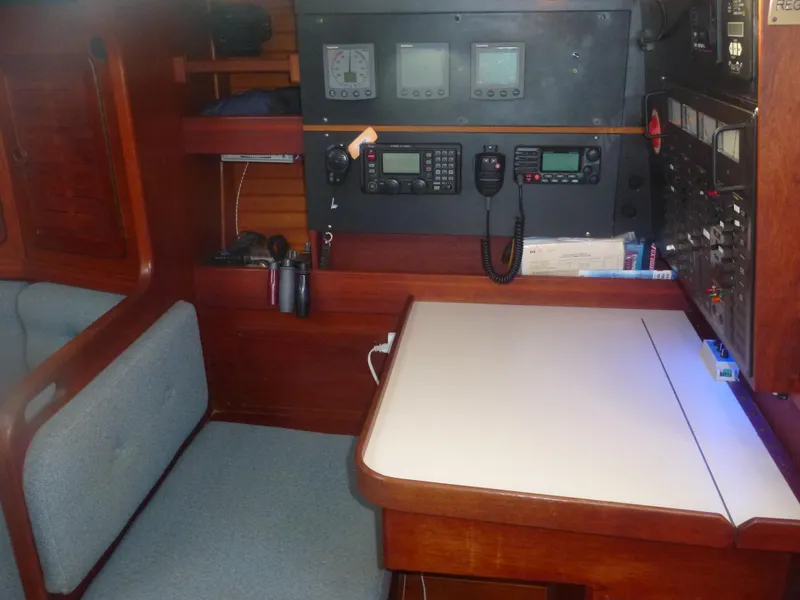 Slide: The Image of Navigation station of a 1990 Sabre 425 sailboat with control panels and seating. - 35