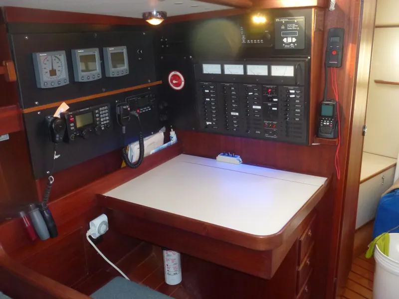 Slide: The Image of Navigation station on a 1990 Sabre 425 sailboat with control panels and communication equipment. - 36