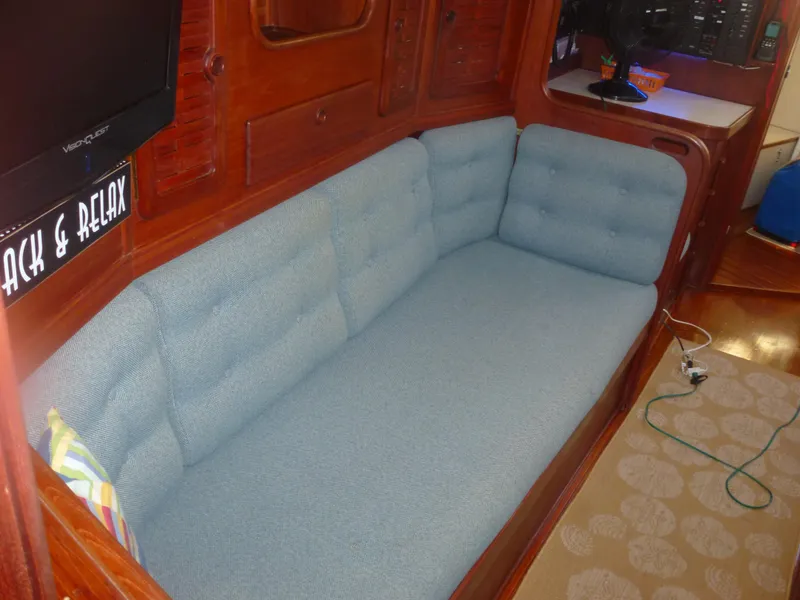 Slide: The Image of Interior of 1990 Sabre 425 sailboat with blue cushioned seating area. - 41