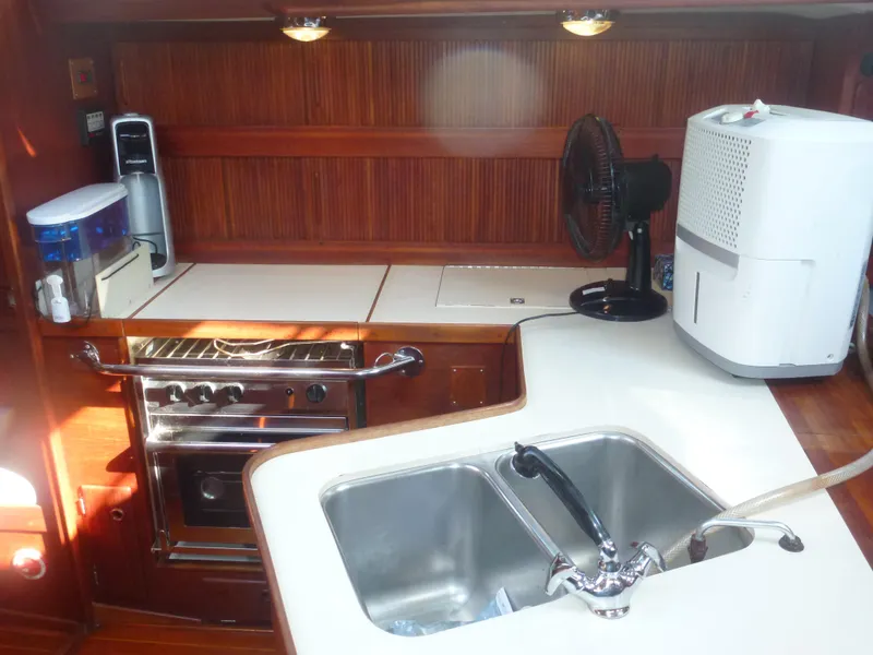 Slide: The Image of 1990 Sabre 425 yacht kitchen with sink, stove, and appliances. - 43