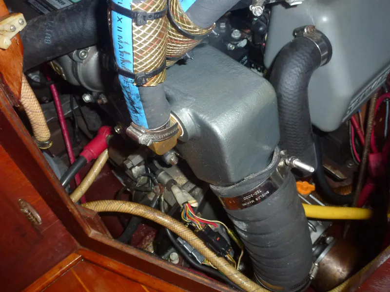 Slide: The Image of Engine compartment of a 1990 Sabre 425 sailboat with various hoses and components. - 45