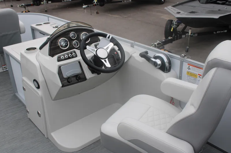 Slide: The Image of 2023 Lowe SF232 Sport Fish boat cockpit with steering wheel and control panel. - 3