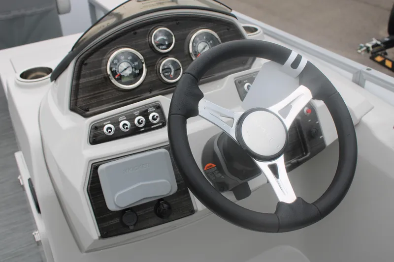 Slide: The Image of 2023 Lowe SF232 Sport Fish boat dashboard with steering wheel and instrument panel. - 4