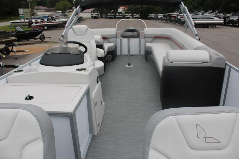 Slide: The Image of 2023 Lowe SF232 Sport Fish pontoon boat interior with seating and steering console. - 8
