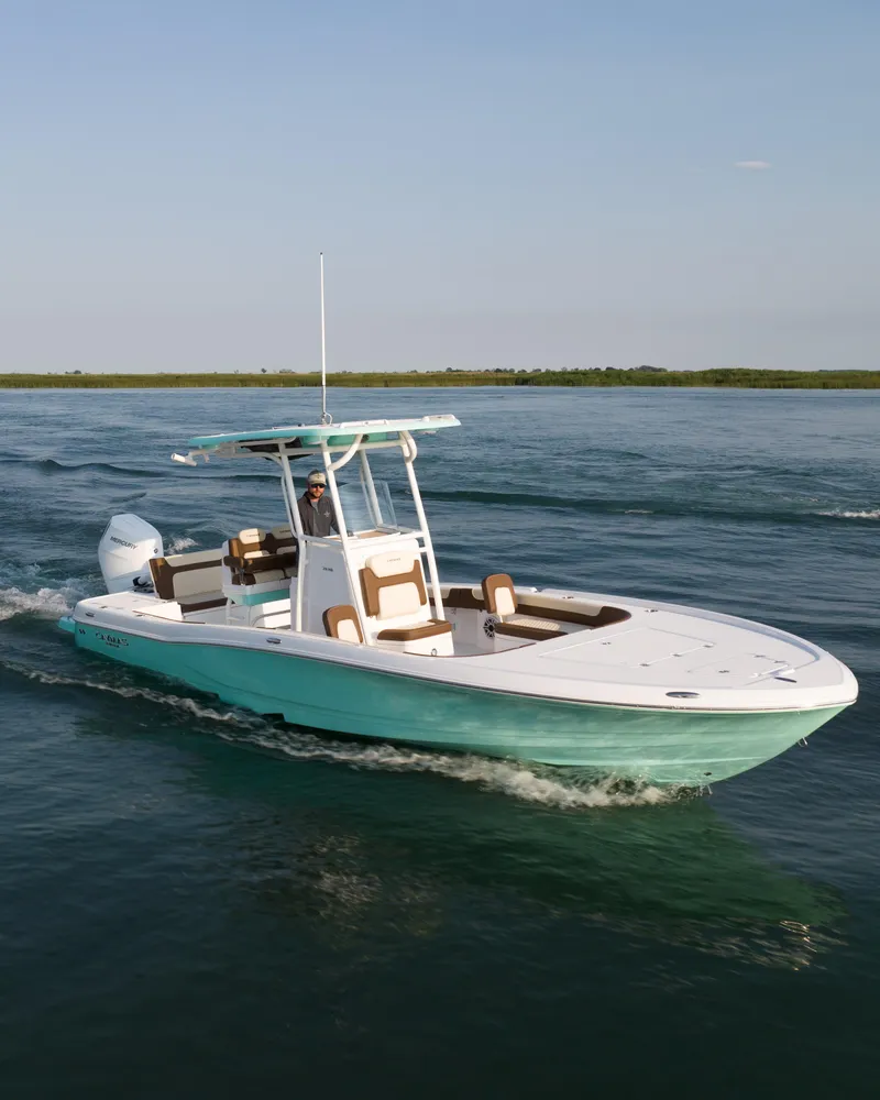 Slide: The Image of 2024 Caymas 28 Hybrid boat cruising on open water. - 12