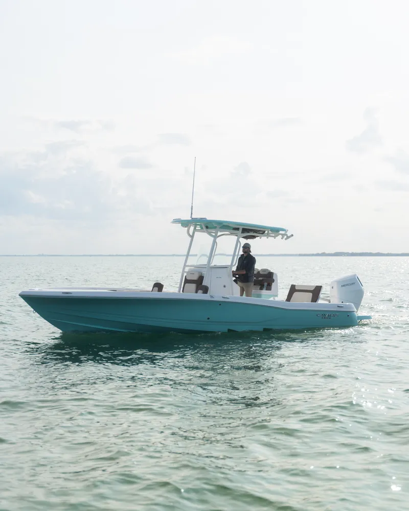 Slide: The Image of 2024 Caymas 28 Hybrid boat cruising on open water. - 13