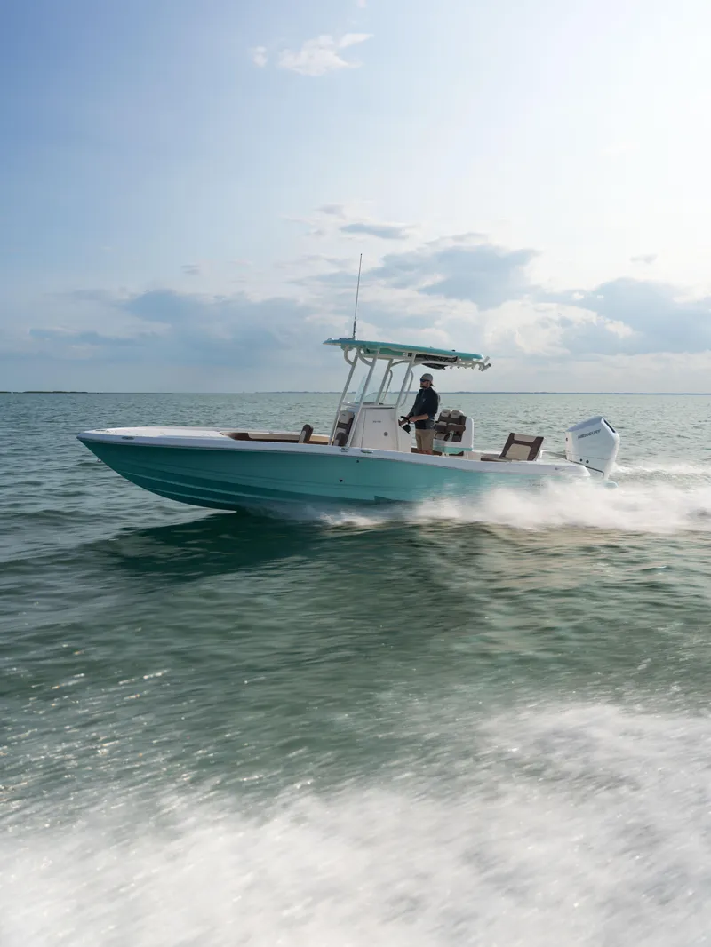 Slide: The Image of 2024 Caymas 28 Hybrid boat cruising on open water. - 14