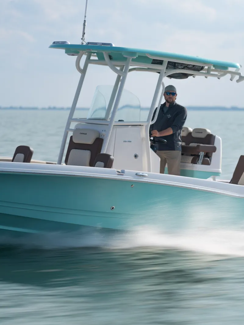 Slide: The Image of 2024 Caymas 28 Hybrid boat cruising on open water. - 15