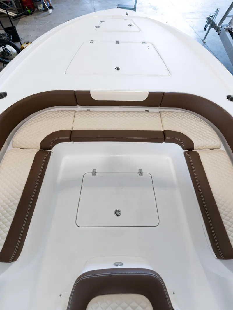 Slide: The Image of 2024 Caymas 28 Hybrid boat interior with cushioned seating and storage compartments. - 16