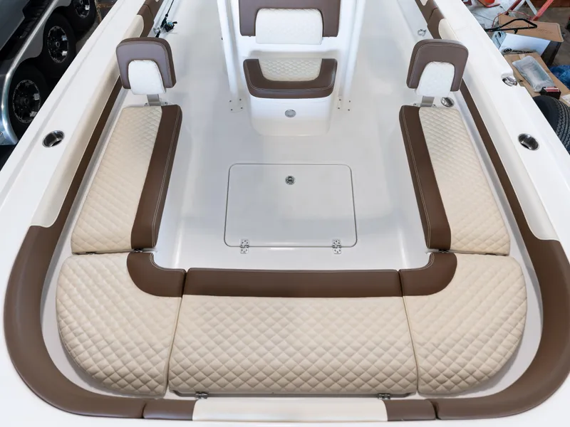Slide: The Image of 2024 Caymas 28 Hybrid boat interior with cushioned seating and storage. - 19