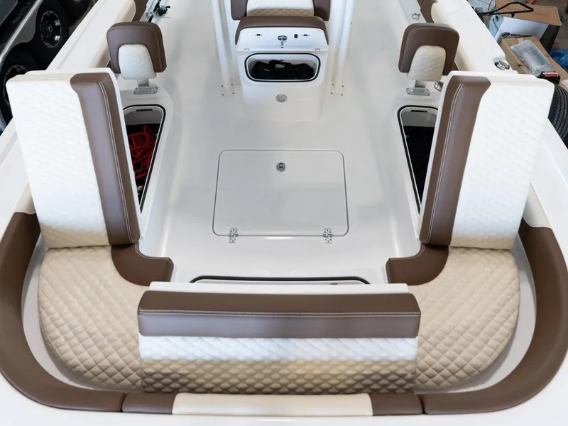 Slide: The Image of 2024 Caymas 28 Hybrid boat interior with cushioned seating and storage compartments. - 20