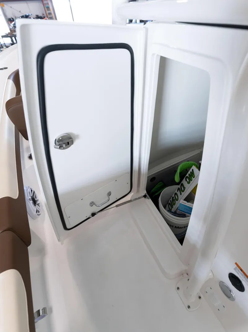 Slide: The Image of 2024 Caymas 28 Hybrid storage compartment with open door. - 30