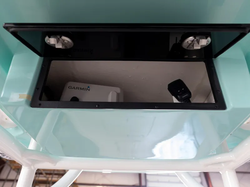 Slide: The Image of 2024 Caymas 28 Hybrid boat storage compartment with Garmin equipment. - 34