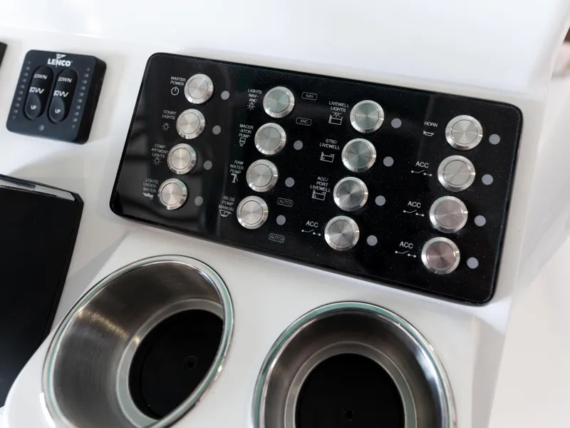 Slide: The Image of Control panel of 2024 Caymas 28 Hybrid boat with cup holders and switches. - 35