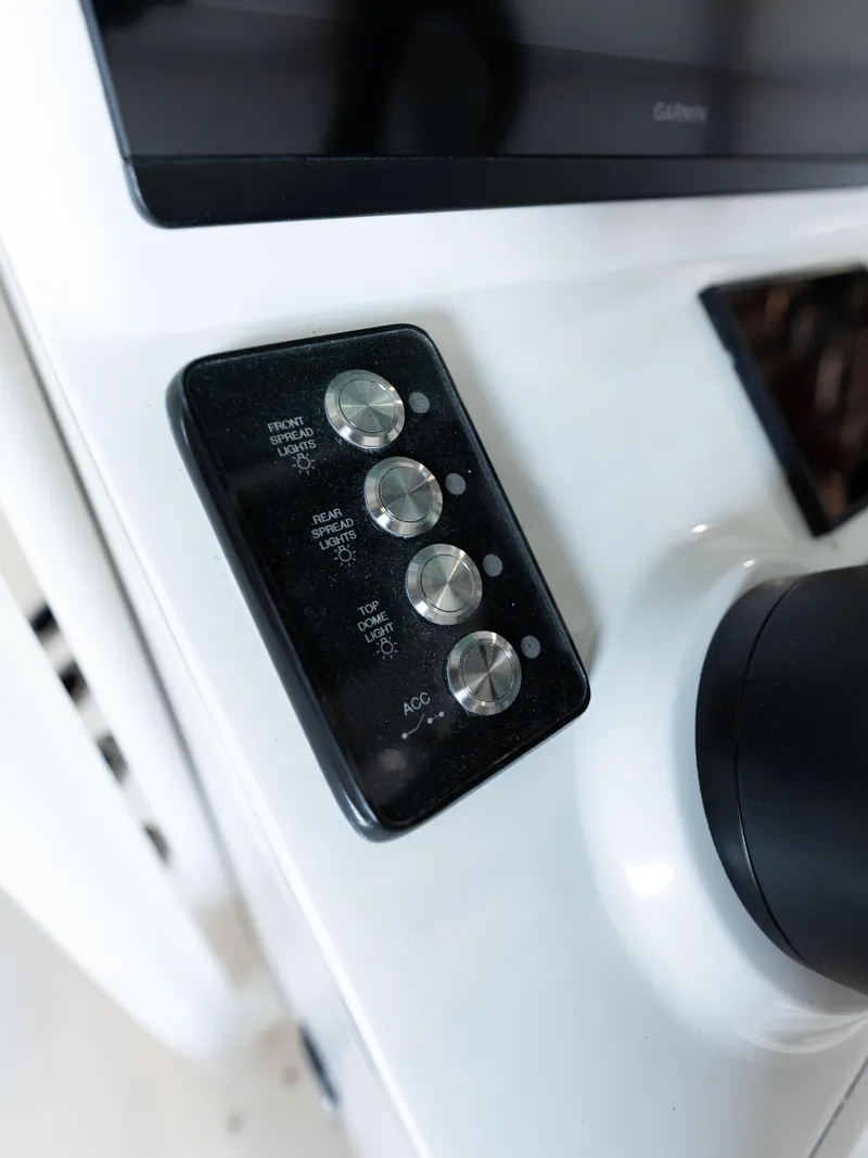 Slide: The Image of Close-up of 2024 Caymas 28 Hybrid boat control panel with buttons and display. - 38