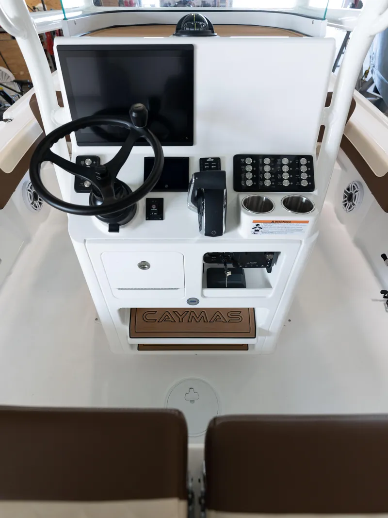 Slide: The Image of 2024 Caymas 28 Hybrid boat console with steering wheel and electronic controls. - 42