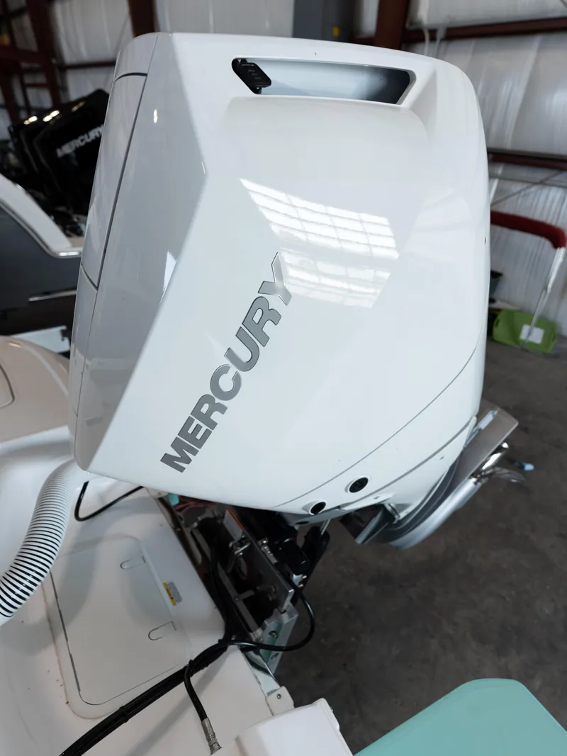 Slide: The Image of 2024 Caymas 28 Hybrid boat with Mercury outboard motor in a showroom. - 46