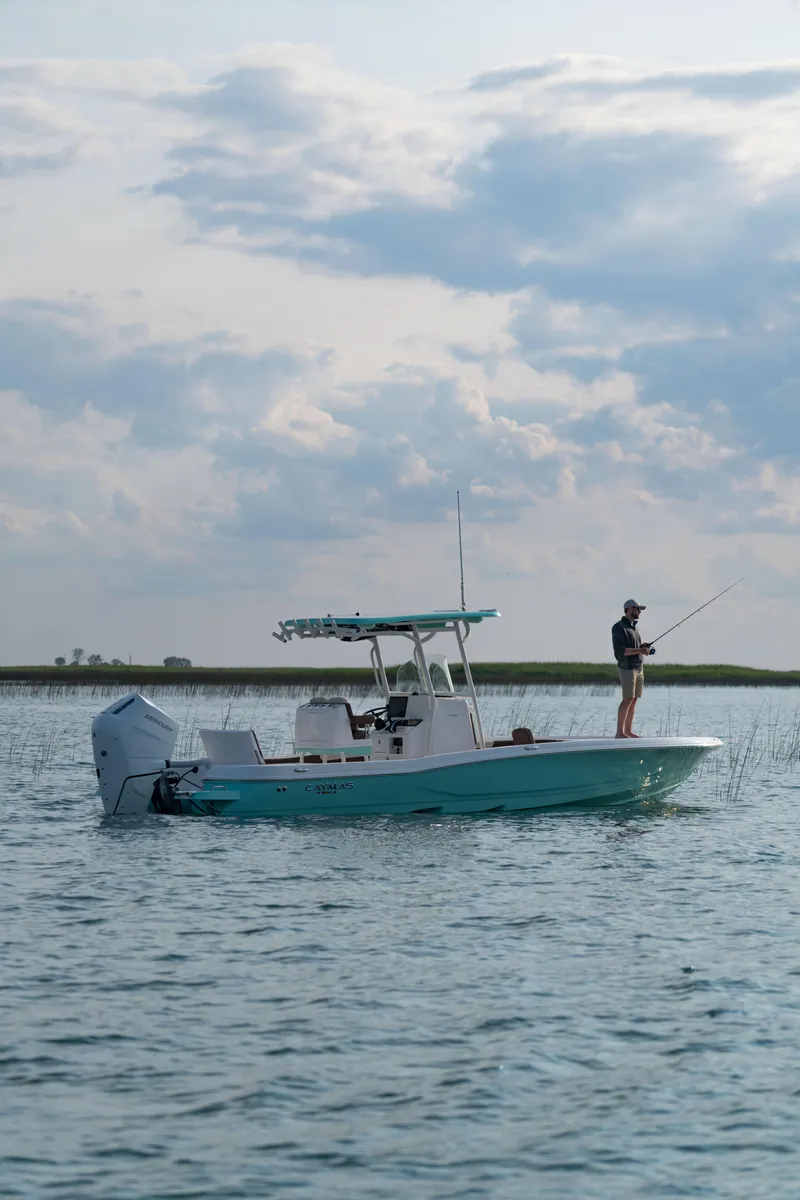 Slide: The Image of 2024 Caymas 28 Hybrid boat on water with person fishing. - 5