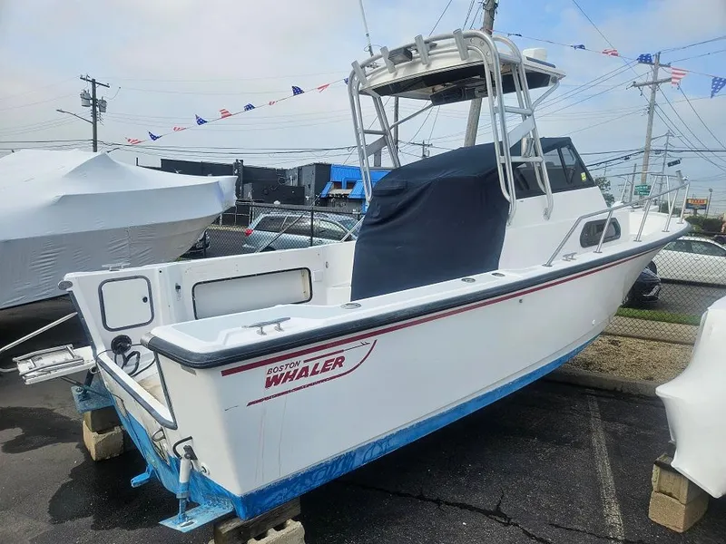 The Image of 1992 Boston Whaler 23 Walkaround boat on display in a marina. - 0
