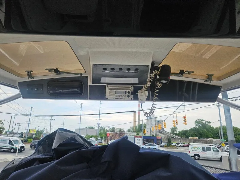 Slide: The Image of 1992 Boston Whaler 23 Walkaround boat dashboard with electronics and radio. - 3