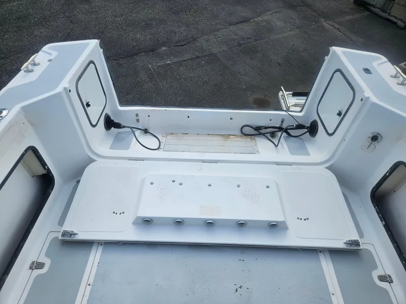 Slide: The Image of 1992 Boston Whaler 23 Walkaround boat interior, featuring storage compartments and clean deck layout. - 9