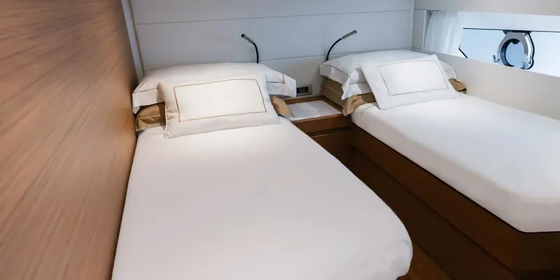 Slide: The Image of Twin beds in a luxurious 2025 Solaris 52 Coupe yacht cabin. - 10