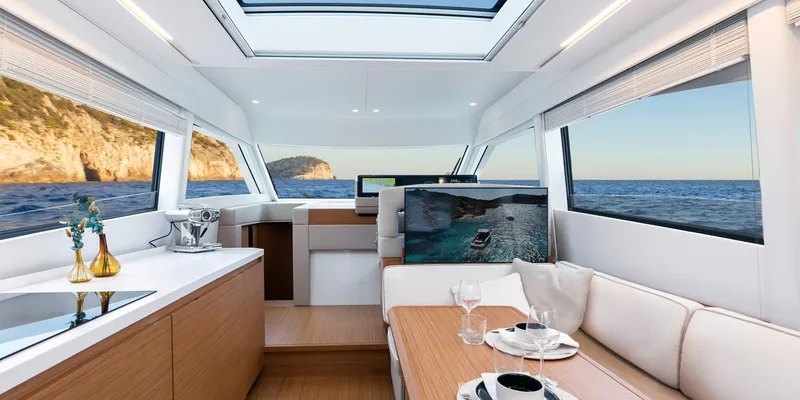 Slide: The Image of Luxurious interior of 2025 Solaris 52 Coupe yacht with ocean view and elegant dining setup. - 5