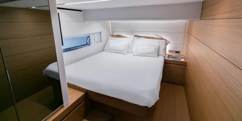 Slide: The Image of Luxurious bedroom interior of 2025 Solaris 52 Coupe yacht with modern design and cozy bedding. - 9