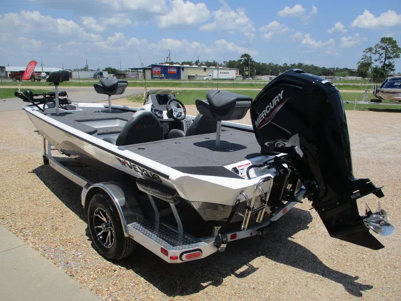 Slide: The Image of 2023 Vexus AVX181 boat with Mercury outboard motor, parked on a trailer. - 5