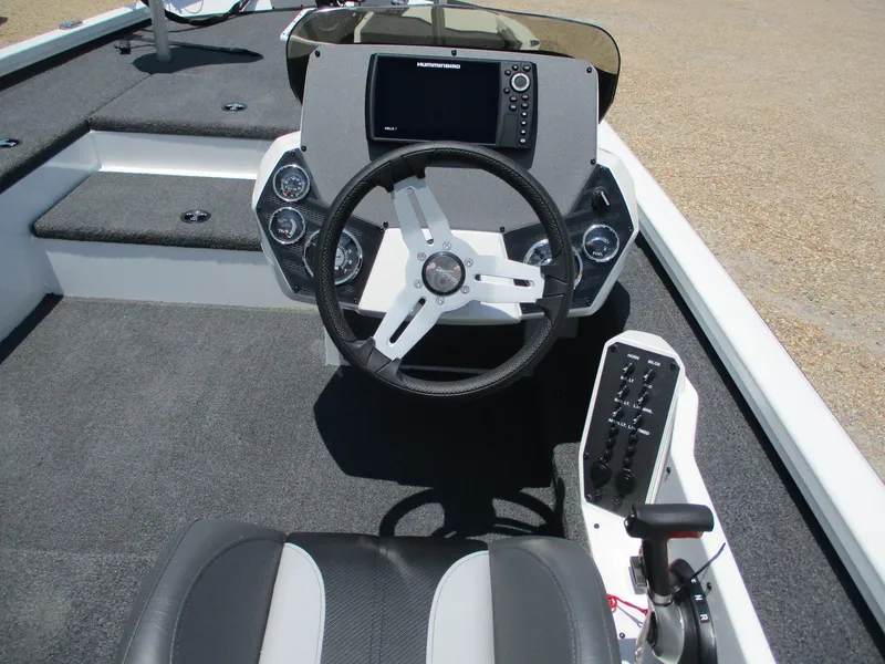 Slide: The Image of 2023 Vexus AVX181 boat cockpit with steering wheel and control panel. - 7