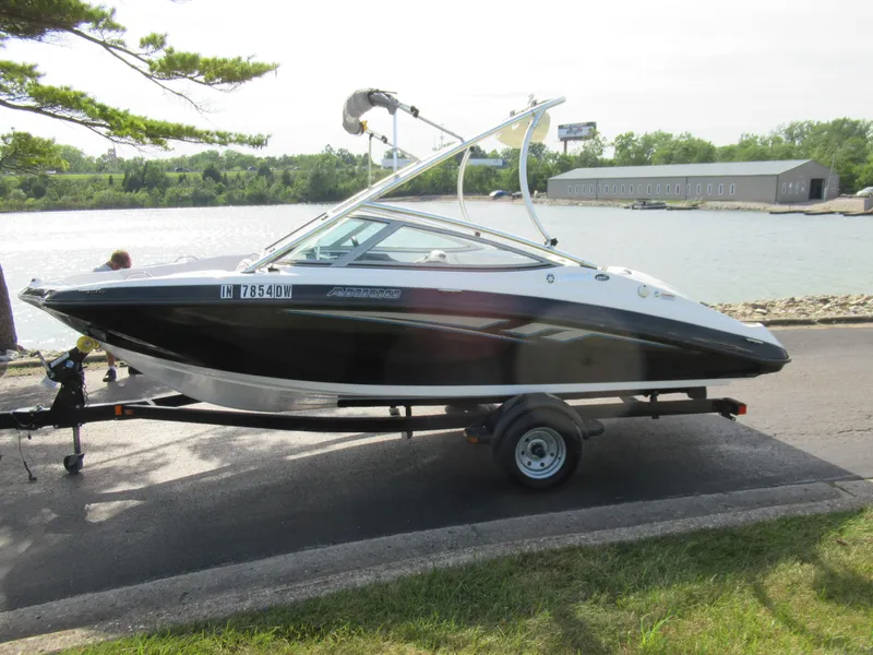 Slide: The Image of 2013 Yamaha Boats AR190 on trailer by a lake. - 12