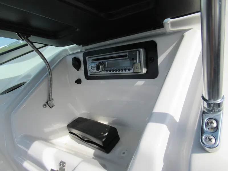 Slide: The Image of 2013 Yamaha Boats AR190 dashboard with stereo system and storage compartment. - 19