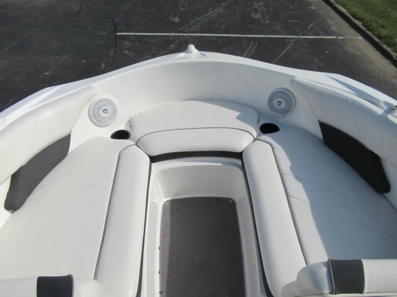 Slide: The Image of 2013 Yamaha Boats AR190 bow seating area with white upholstery and built-in speakers. - 20