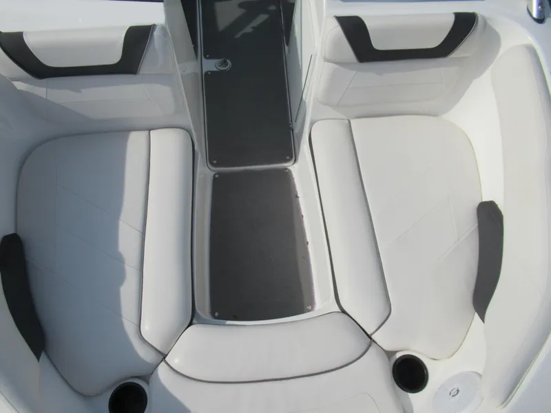 Slide: The Image of 2013 Yamaha Boats AR190 interior seating area with white and black upholstery. - 21