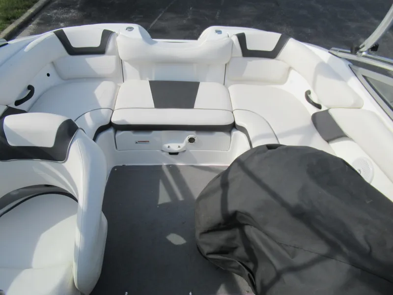 Slide: The Image of 2013 Yamaha Boats AR190 interior seating area with white and black upholstery. - 24