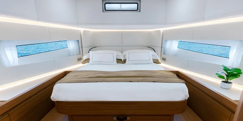 Slide: The Image of Luxurious bedroom interior of 2025 Solaris 52 Coupe yacht with ocean view windows. - 8