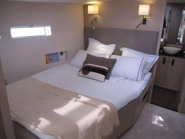 Slide: The Image of Luxurious bedroom in 2024 Jeanneau 55 yacht with modern decor and cozy lighting. - 16